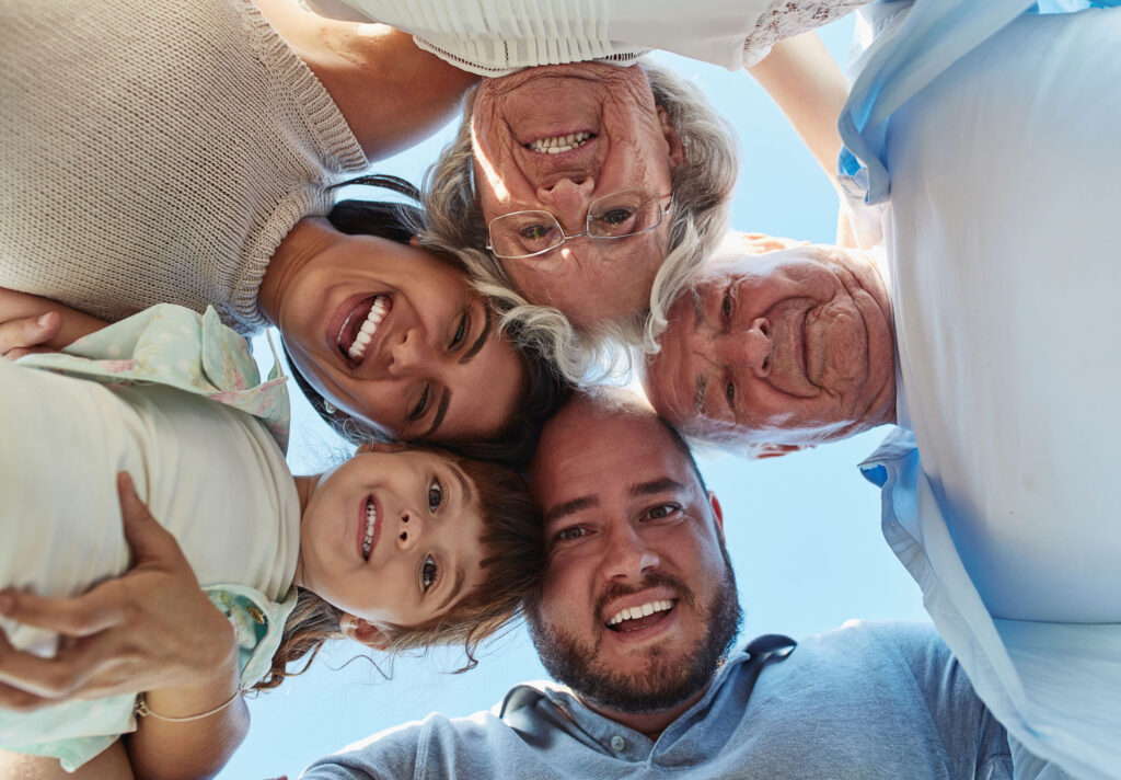portrait-family-huddle-together-outdoor-love-support-bonding-with-generations-face-father-mother-with-grandparents-child-happy-people-laughing-connection-usa